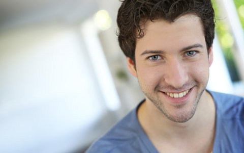 man in blue shirt smiling