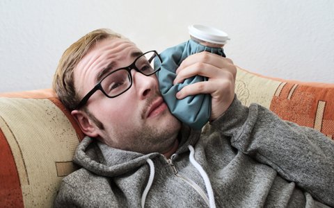 man holding ice pack to jaw