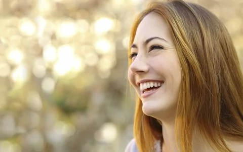 woman smiling to left