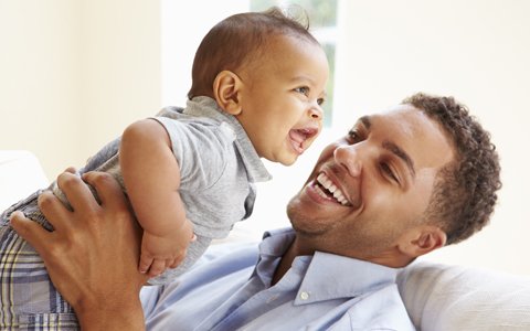 man holding baby up