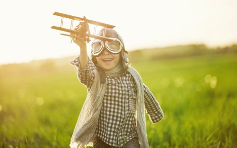 boy playing with airplane