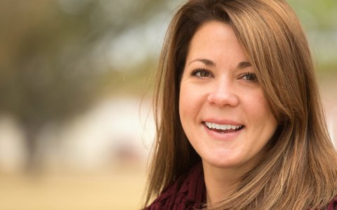 brunette woman smiling at camera