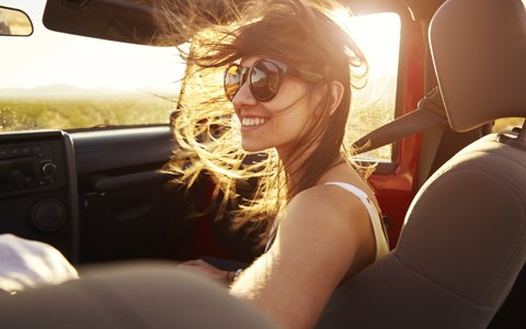 woman in sunglasses riding in car