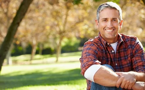 man sitting in field