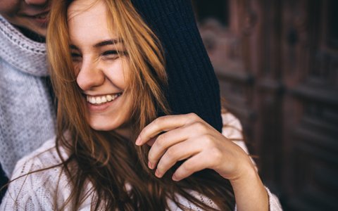 woman in hoodie smiling