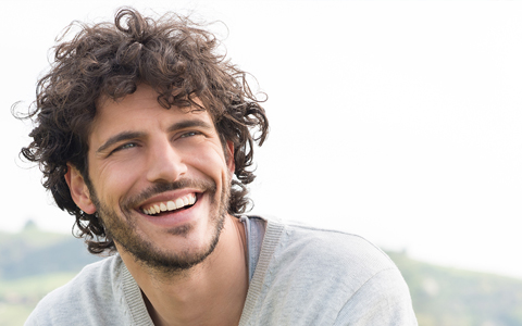 man with dark curly hair